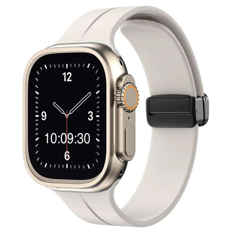 Magnetic silicone sport Apple Watch strap in white with secure pin and tuck closure.